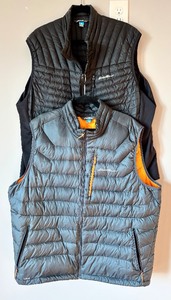 lot 222 image: Two Eddie Bauer Fist Ascent Vests in Black & Grey
