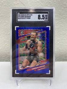 lot 8C image: 2022 Panini Donruss Optic Conor McGregor Blue Velocity Prizm #75 Graded SGC 8.5 J