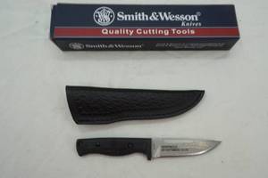 lot 138 image: Smith & Wesson knife with leather ornate sheath