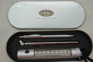 lot 249 image: LED flashlight, pen, and tire pressure gauge