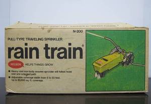 lot 95 image: Unused Vintage NELSON Cast Iron Walking Tractor Sprinkler - Rain Train