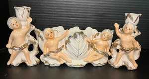 lot 131 image: Three Piece Console Set - Royal Sealy Mid Century Cherub Planter and Candlesticks
