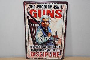 lot 82 image: Novelty Metal Sign -The Problem Isnt Guns