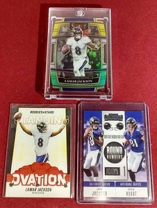 lot 114 image: (3) Lamar Jackson Cards - (1) Die-Cut Prizm