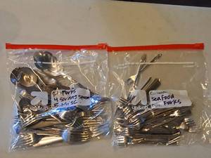 lot 1143 image: Lot of (2 Bags) Assorted Utensils - Seafood Forks, Forks, Servings Spoons, Misc