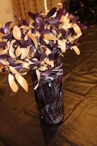lot 28 image: Purple and White Swirl Glass Vase with Decorative Leaves