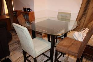 lot 98 image: Glass Top Dining Table with 4 Cushioned Chairs