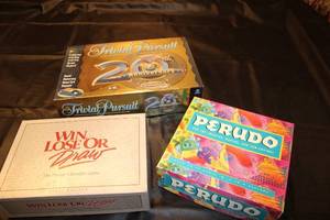 lot 115 image: Collection of 3 Classic Board Games Trivial Pursuit, Win Lose or Draw, Perudo
