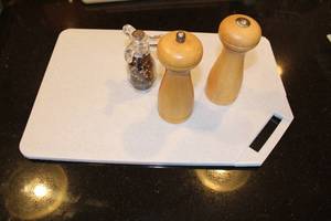 lot 431 image: Wooden Pepper Mill and Salt Shaker Set with Arcoroc Salad Dressing Bottle on Vinderhill Cutting Board