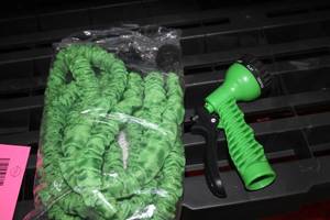 lot 630 image: Expandable Green Garden Hose with Multi-Mode Spray Nozzle