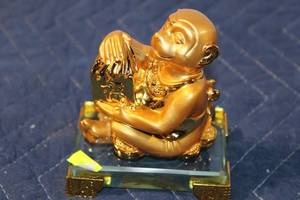 lot 1324 image: Gold-Colored Ceramic Monkey Figurine with Glass Base