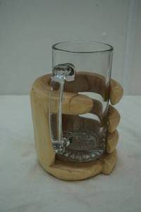 lot 45 image: wooden carved hand holding a large glass beer mug