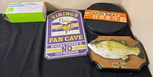 lot 99 image: Assorted Items - Vikings Fan Cave Sign, Silent Spin Seat, Singing Fish, and Security Envelopes