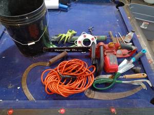 lot 105 image: Electric saw, extension cord, and garden tools