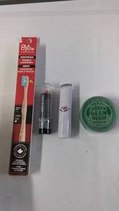 Collection of Eco-Friendly Toothbrush, Lipsticks, and Green Glam Gloss