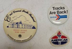 lot 47 image: (1) East Grand Forks Federal - Hand Mirror, (1) Tracks Are Back - Amtrak Badge & (1) American Oil Patch (View Photos)
