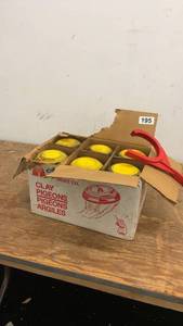 lot 195 image: Box of Clay Pigeons with Handheld Thrower by American Target Co.