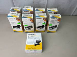 lot 53 image: NEW&nbsp1 Medela 101036149 Pump In Style Advanced Power Adaptor & 8 Medela 67153 Portable Vehicle Adaptor for Medela 12 Volt Breastpumps