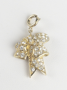 Nolan Miller Glamour Collection rhinestone bow gold tone base metal charm.