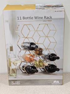 lot 22 image: BRAND NEW WOMEN OWNED 11 BOTTLE WINE RACK W GOLD FINISH