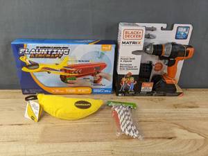lot 226 image: New Kids Toys and Games Banana grams, Flaunting Aircraft Launcher Toy, Black and Decker Matrix Junior Power Drill Toy, and a Jump Rope  B
