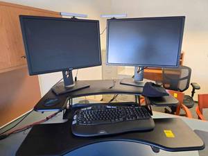 lot 200 image: Adjustable desk, computer monitor, keyboard, camera and dock station