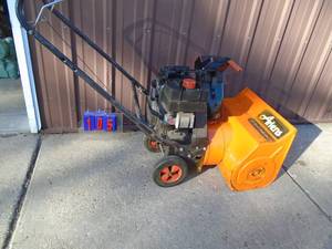 lot 105 image: Ariens 5 hp snow blower. Used condition. Tested & works. As shown.