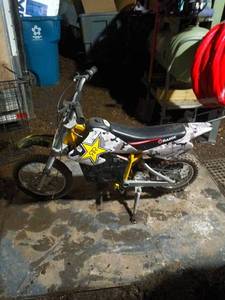 lot 35 image: Razor Electric Dirt Bike with Camo Wrap - Works, No Charger