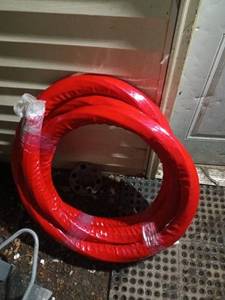 lot 56 image: Coiled Red Air Hose for Industrial Use