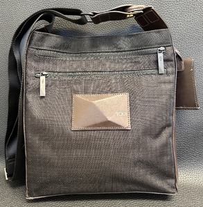 lot 51 image: Tumi Canvas Messenger Brown and Black Crossbody Bag with Adjustable Strap