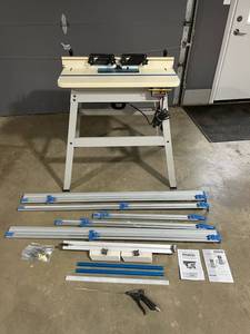 lot 40 image: Rockler Woodworking  Router Table (24 x 31.75) with Porter Cable Model 7518 Router & Accessories in Good Working Condition ($800 Retail)