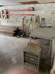 lot 180 image: YardGarden Tools, Work Bench, Vintage Modine Heater, and Scrap Wood - Bring Help to Remove (Located in Barn)