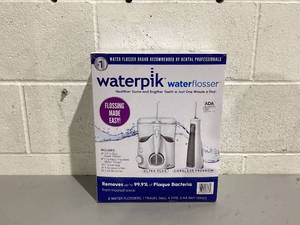lot 563 image: Waterpik Ultra Plus and Cordless Express Water Flosser