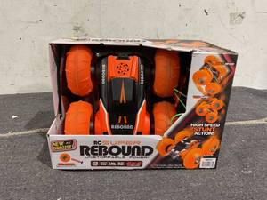 lot 203 image: New Bright (116) Super Rebound Battery Remote Control Orange Stunt Vehicle