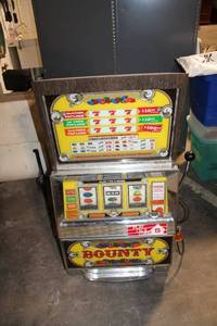 lot A-327 image: Vintage Bounty Slot Machine with Wooden Cabinet