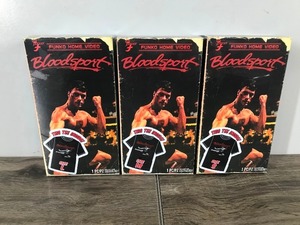 lot 147 image: 3 - Bloodsport Collectible Jean Claude Van Damme T-Shirts in a VHS boxes (just t-Shirts - no VHS) sizes small - medium - large