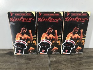 lot 148 image: 3 - Bloodsport Collectible Jean Claude Van Damme T-Shirts in a VHS boxes (just t-Shirts - no VHS) sizes small - medium - large