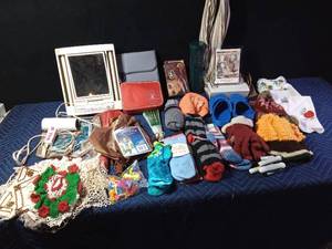 lot 318 image: Doilies, umbrellas, make-up mirror, first aid kit, curling iron Crocs, soft socks, gloves, barrettes, bird feeder, handkerchiefs, musical picture frame