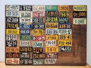 lot 167 image: Awesome Complete 1950s Mini License Plate Set Mounted on Old Display Board
