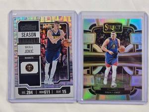 lot 163 image: Lot of 2 Nikola Jokic Silver Holo Cards -2023-24 Panini Select Concourse No. 32, Panini Contenders No. 1