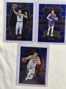 lot 244 image: Lot of 3 Nikola Jokic Cards - 2023-24 Panini Concourse No. 32, 2022-23 Panini Premier Level No. 101, 2021-22 Premier Level No. 109