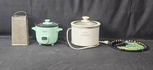 lot 21 image: Set of Kitchen Appliances and Accessories (untested) including Crock-Pot, Rice Cooker, Grater, and Decorative Plate