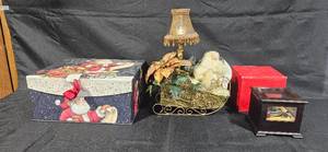 lot 513 image: Holiday Decor Set with Santa Themed Sleigh, Gift Boxes, and Miniature Display