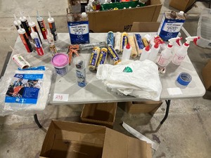 TABLE FULL OF PAINT SUPPLIES, PAINT THINNER, PAINT SUIT, ROLLERS, SPRAY BOTTLES, TEXTURE,RAGS, CAULK, & CAULKING GUN