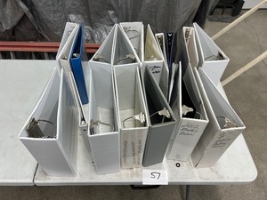 TABLE FULL OF BINDERS OF VARIOUS SIZES