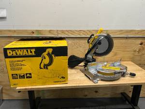 lot 115 image: DEWALT DWS713 15 Amp Corded 10 in. Compound Single Bevel Miter Saw - C249