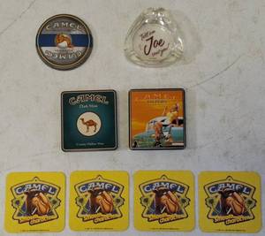 lot 36 image: Vintage Camel  (1) Camel Dark Mint - Creamy Mellow Mint Tin (1) Camel Filters - Pleasure to Burn Tin (1) Clear Glass Ashtray (4) Yellow Camel Coasters (1) Camel Tin Lid (View Photos)