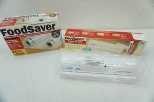 lot 55 image: Food saver Store N Cut and unopened box of quart bags and rolls