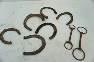 lot 98 image: antique horseshoes and bits