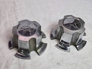 lot 34 image: Set of 2 Chevrolet Wheel Center Caps - 1 is Heavier than the Other